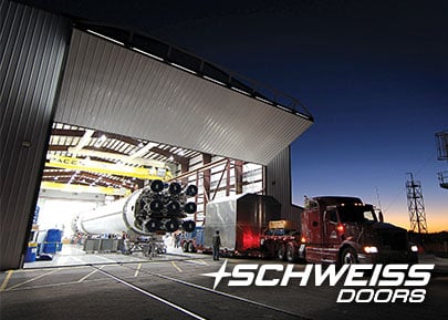Rocket Hangar has a Schweiss Bifold Door at night