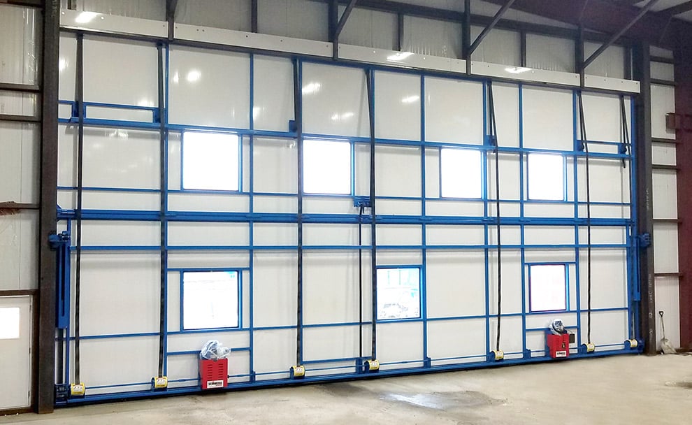 Strap Latch Bifold Hangar Door with Blue doorframe