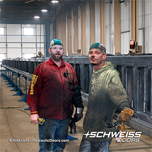 Schweiss Employees working on Large Liftstrap Doors